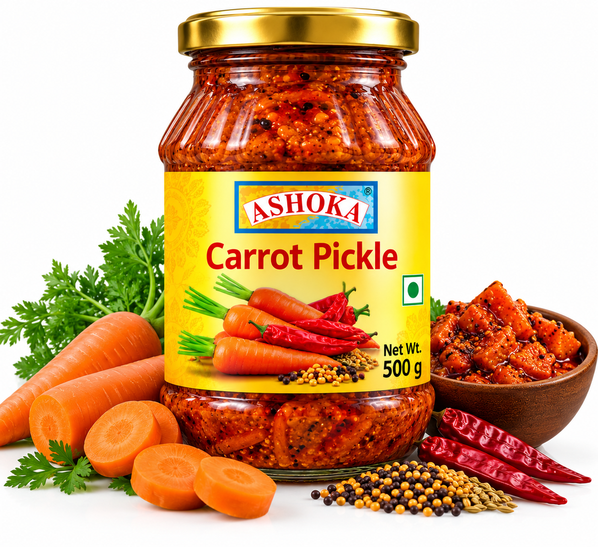 Ashoka Carrot Pickle 500g featuring a glass jar with a gold lid and yellow label, filled with spicy carrot pickle, alongside fresh orange carrots, sliced carrots, green leaves, dried red chillies, mustard seeds, and aromatic Indian spices.