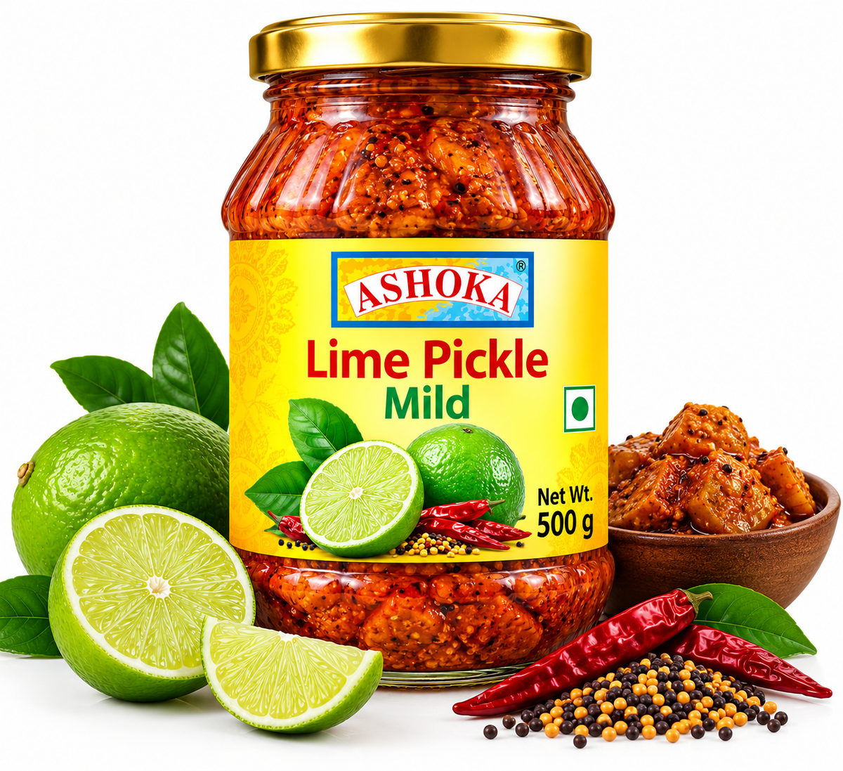 Ashoka Lime Pickle Mild 500g featuring a glass jar with a gold lid and yellow label, filled with traditional mild lime pickle, alongside fresh green limes, sliced citrus, green leaves, mustard seeds, dried red chillies, and authentic Indian pickle spices.