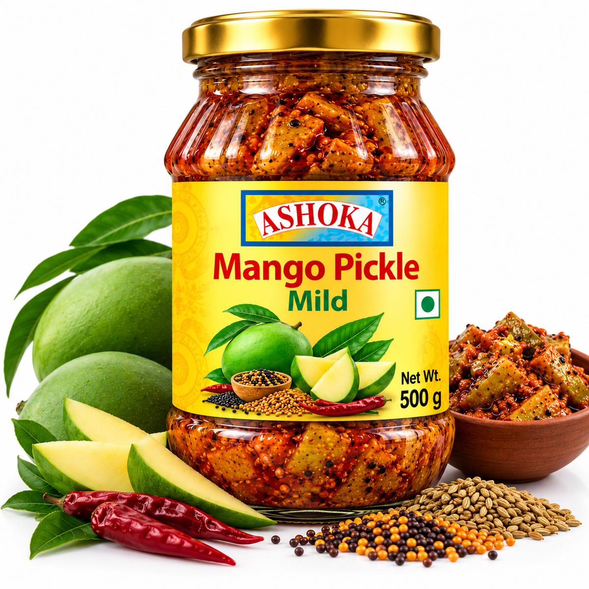 Ashoka Mango Pickle Mild 500g featuring a glass jar with a gold lid and yellow label, filled with mild, tangy mango pickle, alongside fresh green mangoes, mango slices, green leaves, mustard seeds, and traditional Indian spices.