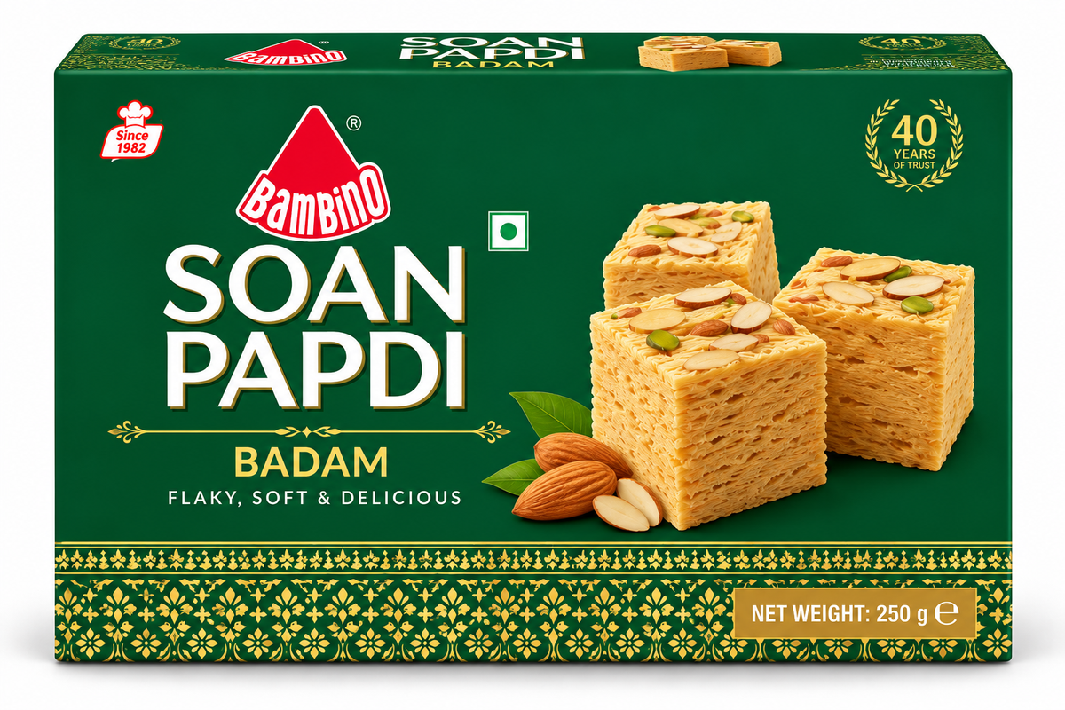 Bambino Soan Papdi Badam 250g sweet box featuring dark green packaging with gold decorative patterns, flaky soan papdi cubes topped with almonds and pistachios.