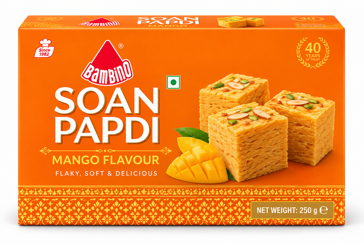 Bambino Soan Papdi Mango Flavour 250g sweet box featuring bright orange packaging, flaky mango-flavoured soan papdi cubes, fresh mango pieces, almonds, and pistachios.