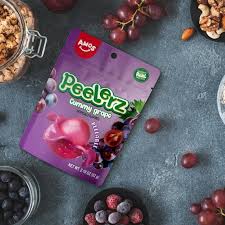 170g pack of Peelerz A-Peel Gummy Candy in Grape Flavour, featuring a bright purple bag with the “A-Peel” logo and images of gummy strips and grapes.