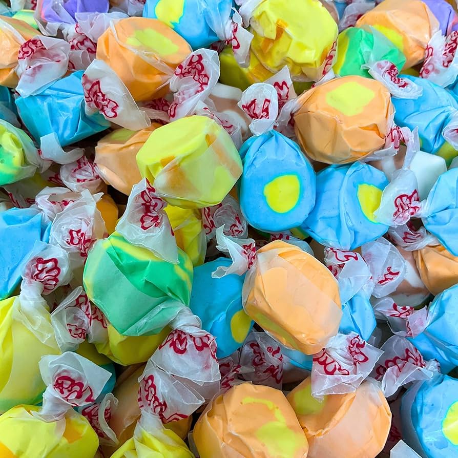 Soft and chewy banana salt water taffy mix spilling from pouch.