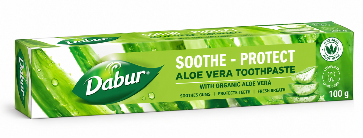 Dabur Aloe Vera Toothpaste 100g carton featuring bright green and white packaging, the green Dabur logo, bold “Soothe-Protect” and “Aloe Vera Toothpaste” lettering, and illustrations of fresh aloe vera leaves and aloe gel slices. The product box is displayed at an angle against a clean white background.