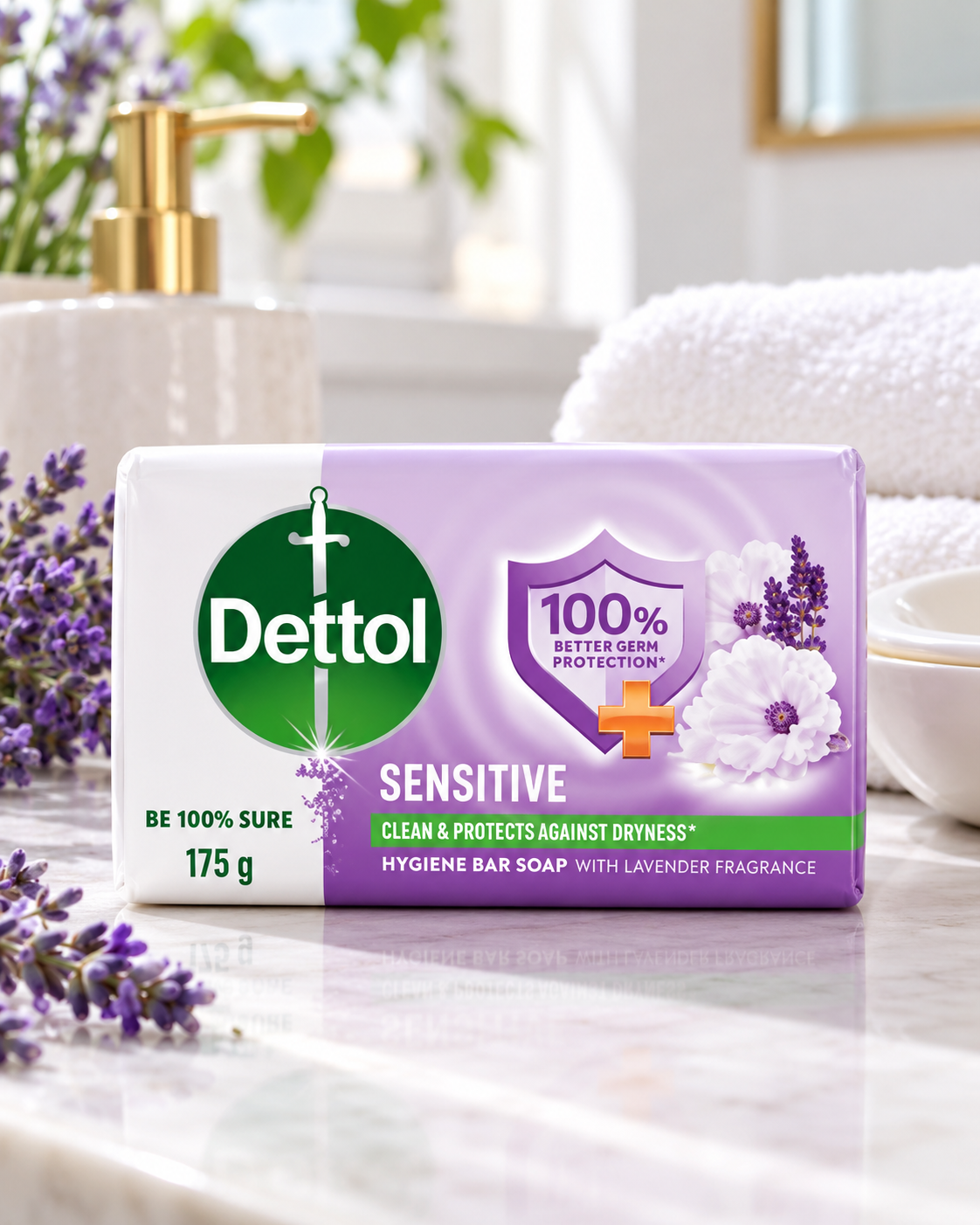 Dettol Sensitive Soap 175g in white and lavender packaging displayed on a bright bathroom countertop beside lavender flowers, a white towel, and a soap dish.