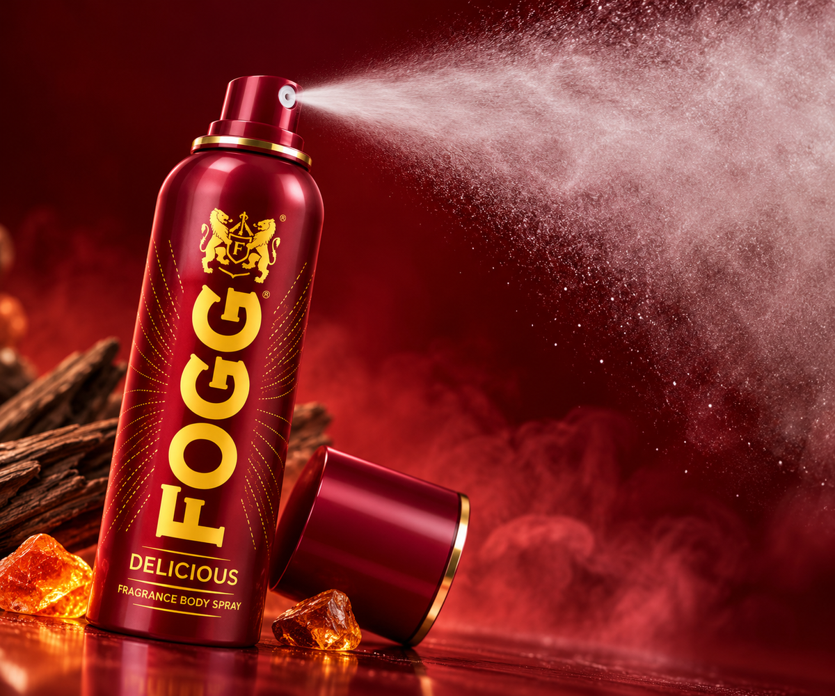 FOGG Delicious red fragrance body spray releasing a fine mist with gold detailing against a dramatic red background.