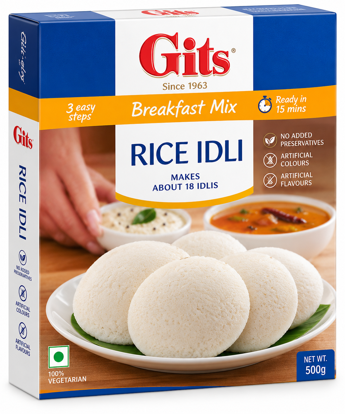 Gits Rice Idli Breakfast Mix 500g featuring a rectangular box with white, dark blue, and orange packaging, the iconic red Gits logo, Breakfast Mix branding, and prominent Rice Idli lettering. The front of the pack displays soft, fluffy white idlis served on a plate alongside bowls of sambar and coconut chutney, with details highlighting preparation in 15 minutes, approximately 18 idlis, and no added preservatives, artificial colours, or artificial flavours. Displayed against a clean white background.