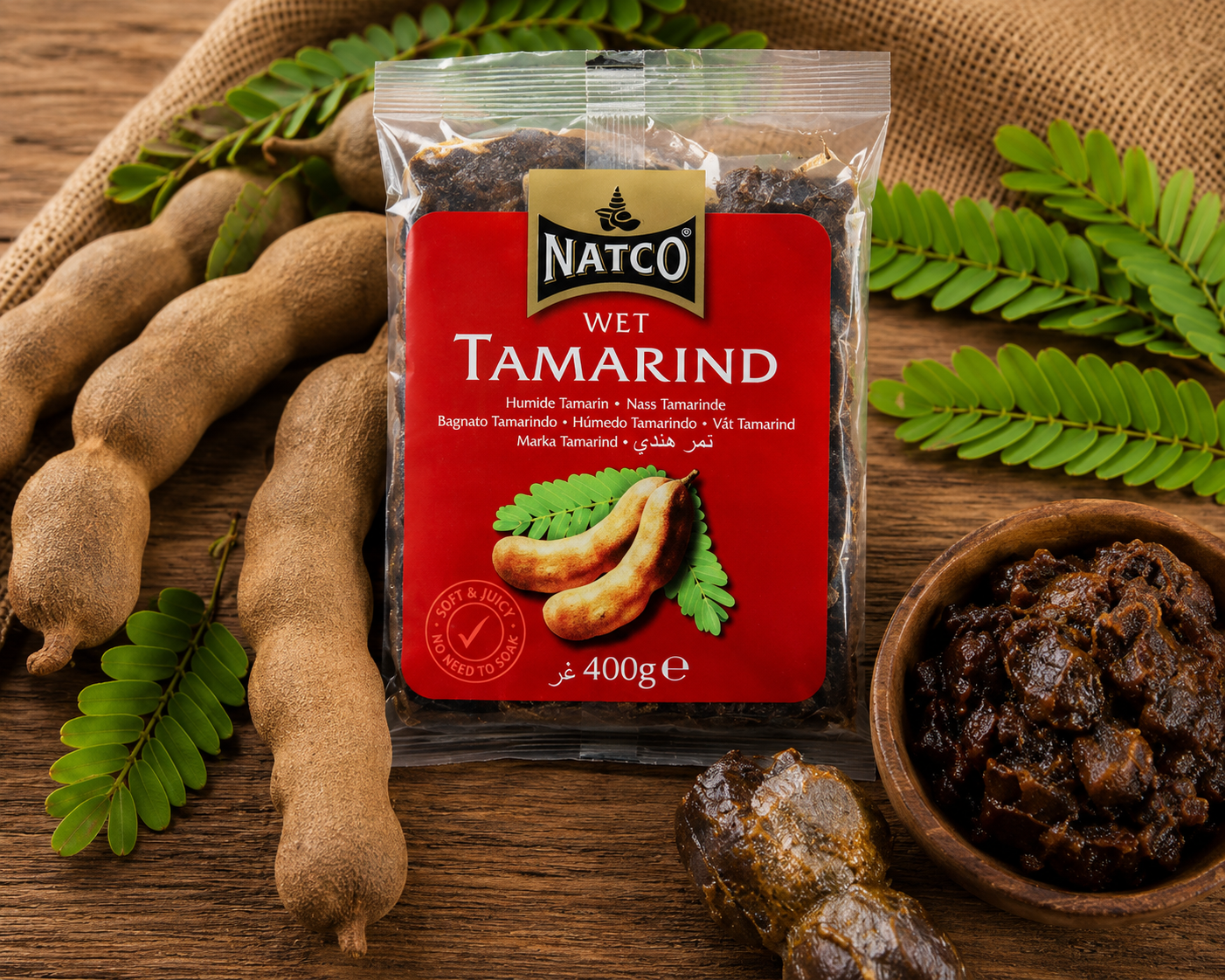 Natco Wet Tamarind 400g beautifully presented with fresh tamarind pods and tamarind pulp in a rustic setting, highlighting its authentic flavour for curries, chutneys and traditional recipes.