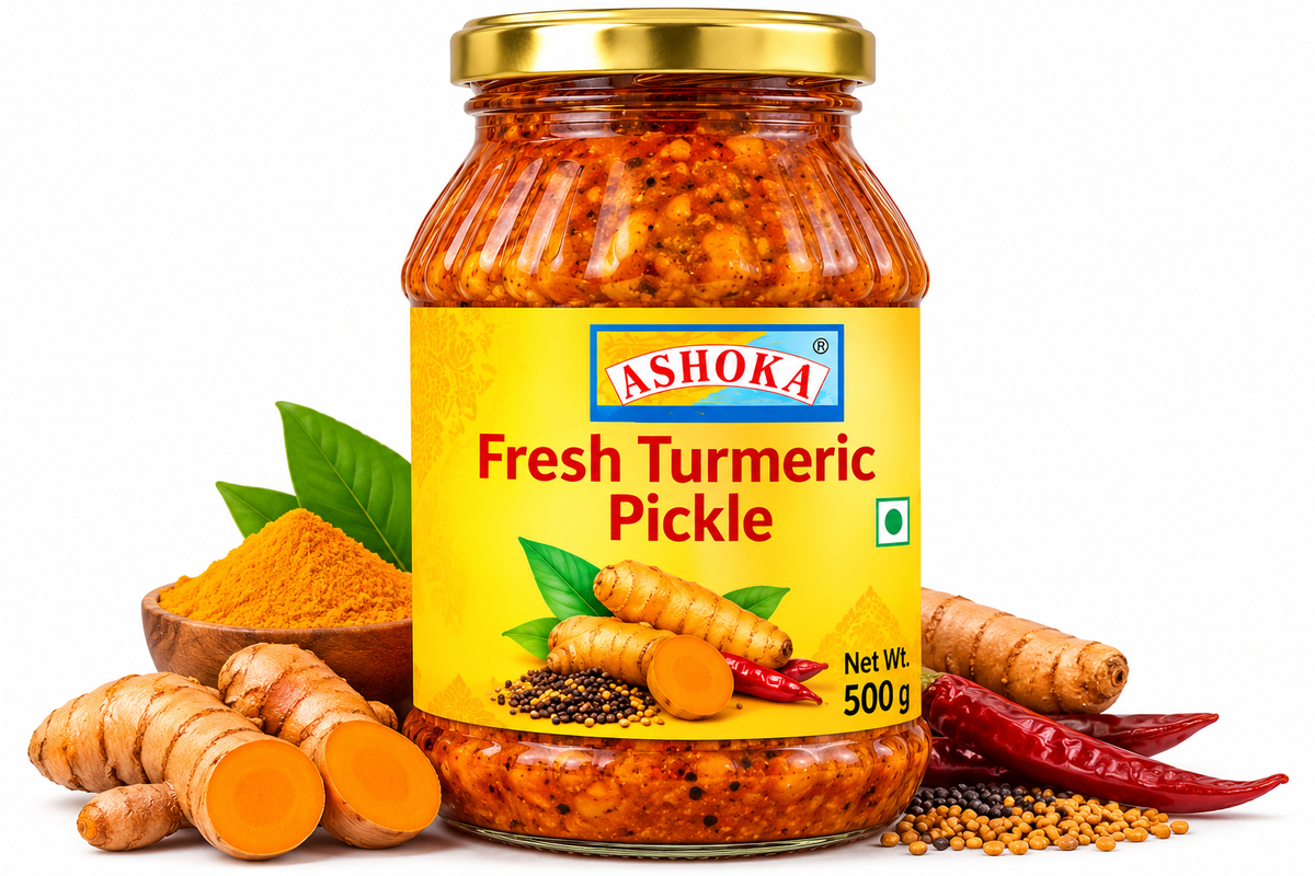 Ashoka Fresh Turmeric Pickle 500g featuring a glass jar with a gold lid and bright yellow label, filled with fresh turmeric pickle and aromatic spices, alongside fresh turmeric roots, sliced turmeric, turmeric powder, green leaves, mustard seeds, and dried red chillies.