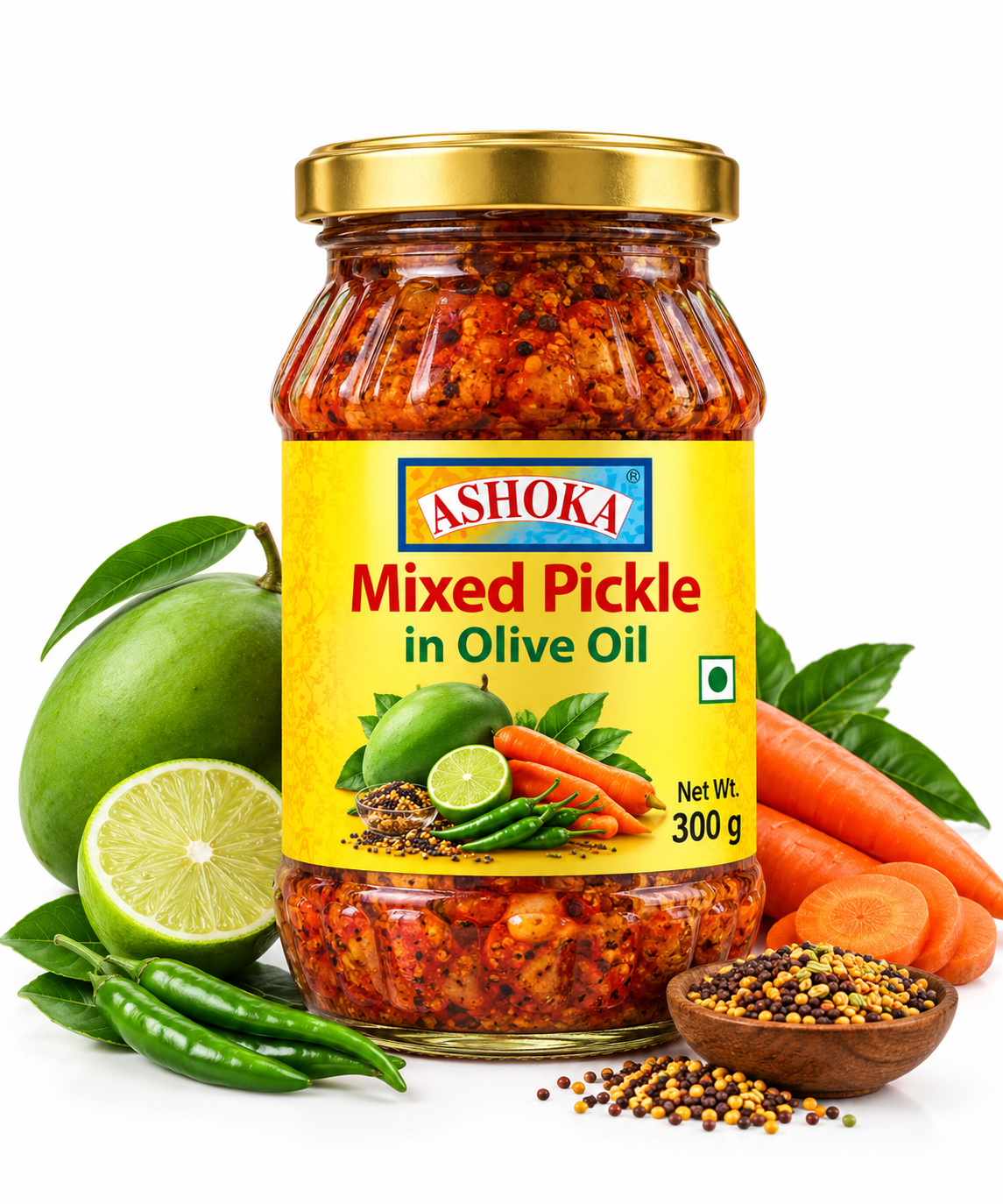 Ashoka Mixed Pickle in Olive Oil 300g featuring a glass jar with a gold lid and bright yellow label, filled with traditional Indian mixed vegetable pickle, alongside fresh green mangoes, lime, carrots, green chillies, leafy greens, mustard seeds, and aromatic spices.