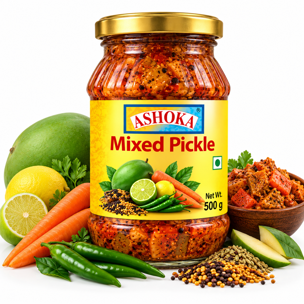 Ashoka Mixed Pickle 500g featuring a glass jar with a gold lid and yellow label, filled with spicy mixed vegetable pickle, alongside fresh green mangoes, carrots, lime, green chillies, mustard seeds, and traditional Indian spices.