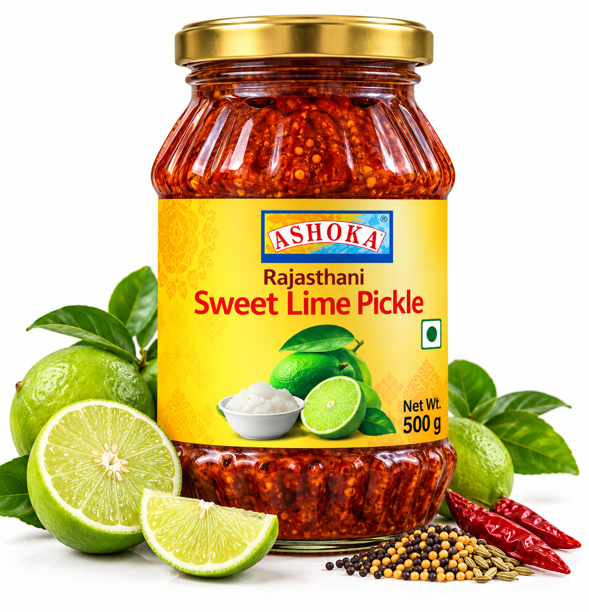 Ashoka Rajasthani Sweet Lime Pickle 500g featuring a glass jar with a gold lid and bright yellow label, filled with traditional sweet and tangy lime pickle, alongside fresh green limes, sliced lime, green leaves, mustard seeds, fennel seeds, dried red chillies, and aromatic Indian spices.