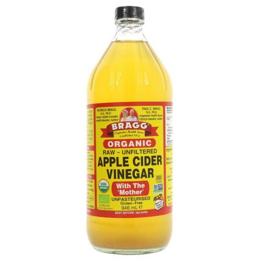 Bragg Organic Apple Cider Vinegar 946ml glass bottle with yellow label, raw unfiltered vinegar with the Mother for cooking and wellness use.