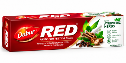 Dabur Red Toothpaste 100ml in red and white packaging, featuring Ayurvedic herbs, green leaves and oral care benefits for teeth and gums.