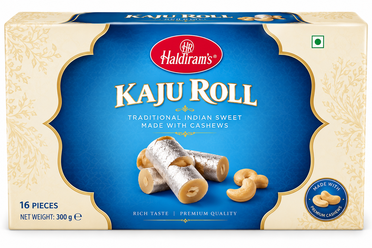 Haldiram’s Kaju Roll sweet box in cream and blue packaging with gold detailing, featuring cashew-filled rolls coated in edible silver leaf and premium cashew illustrations.