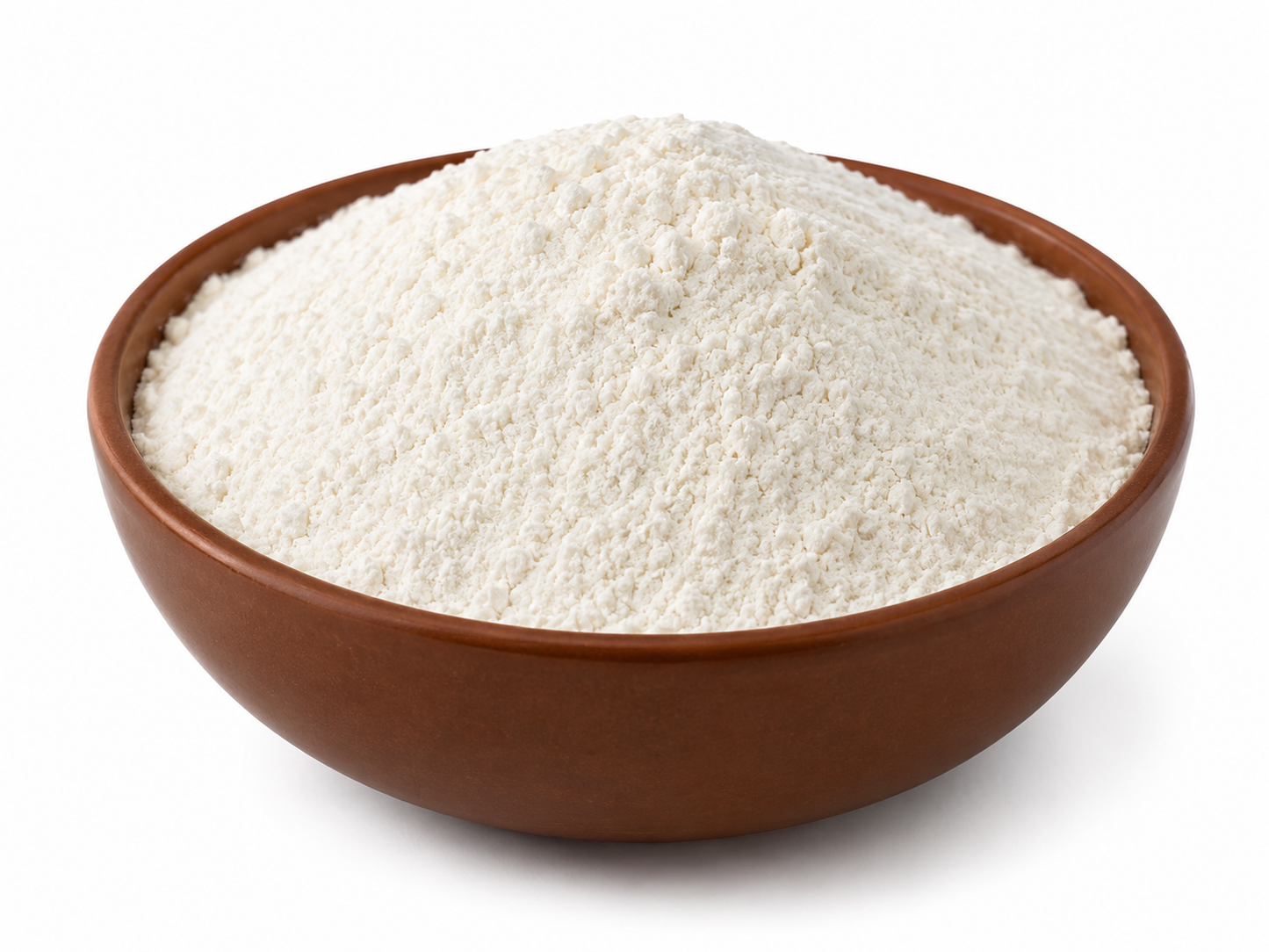 A mound of white flour piled in a brown ceramic bowl against a plain white background.