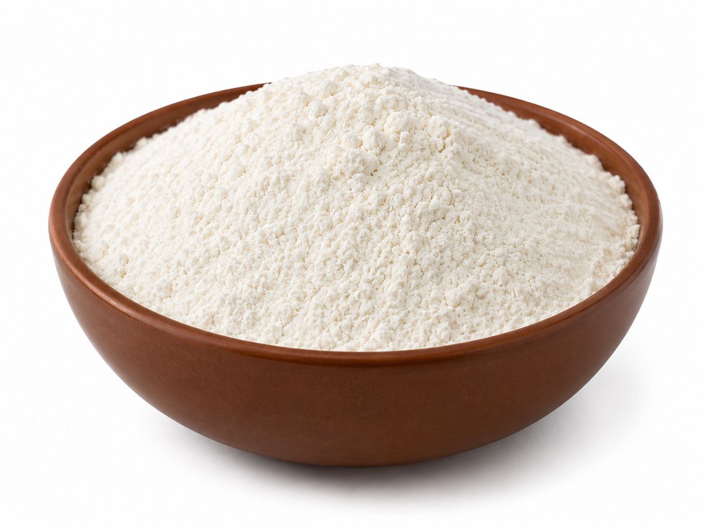 A mound of white flour piled in a brown ceramic bowl against a plain white background.