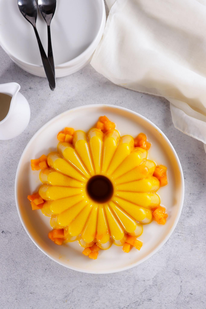 Mango Jell-O cubes served on white plate.