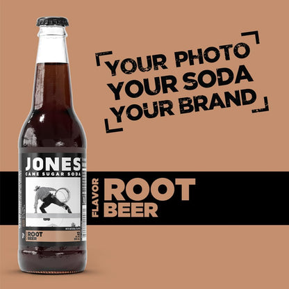 Close-up view of a Jones Soda Root Beer bottle showing the deep brown color of the soda through clear glass, emphasizing its classic root beer appearance and creamy vanilla flavor profile.