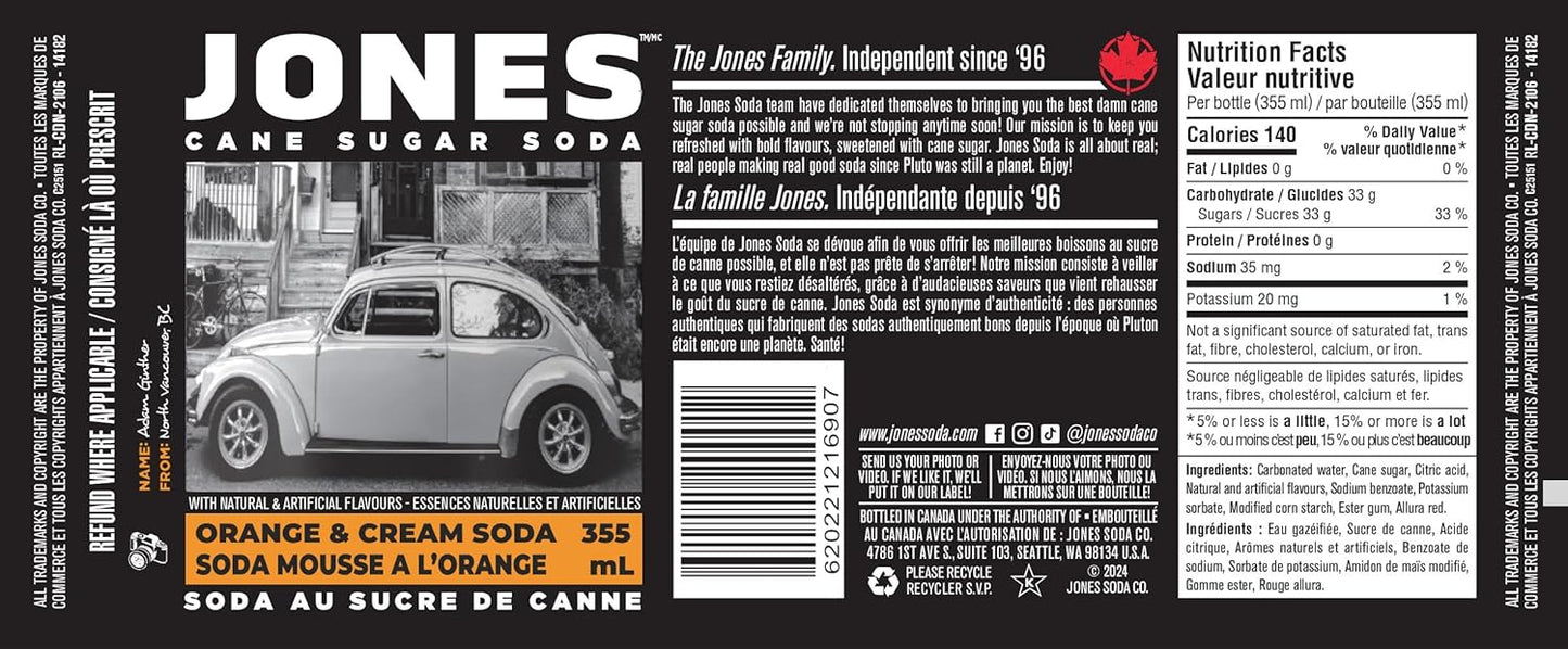 Close-up of a Jones Soda Orange & Cream 355ml bottle showing the vivid orange color of the soda through clear glass, emphasizing the creamy orange flavor and classic soda-shop aesthetic.
