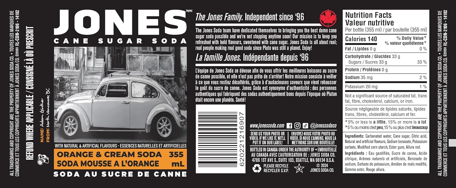 Close-up of a Jones Soda Orange & Cream 355ml bottle showing the vivid orange color of the soda through clear glass, emphasizing the creamy orange flavor and classic soda-shop aesthetic.