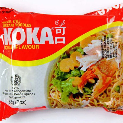 Koka Crab Flavour Noodles 85g instant noodle packet featuring seafood-themed packaging alongside a prepared bowl of wheat noodles in savoury crab-flavoured broth. Single serve instant noodles ideal for quick meals, office lunches, student snacks and convenient everyday cooking.