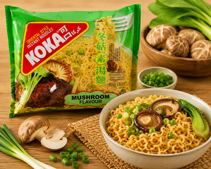 A package of Koka Mushroom Flavour instant noodles shown next to a bowl of prepared noodles with shiitake mushrooms, green onions, and scallions on a wooden table.