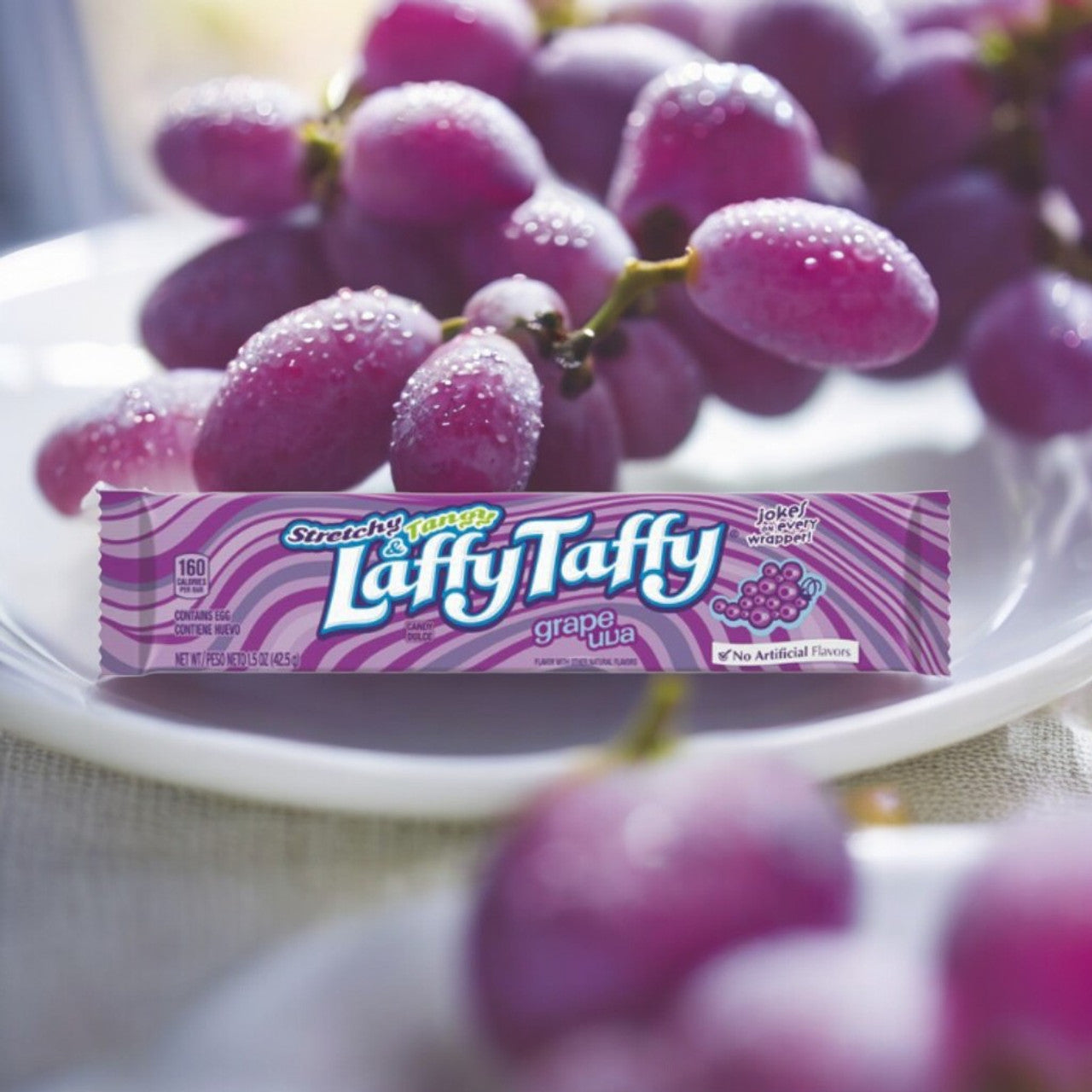 Laffy Taffy Grape bar close-up stretchy fruit-flavoured taffy with jokes on wrappers.