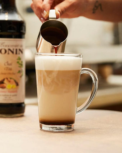 Monin Premium Chai Tea Concentrate bottle, 700ml, showcasing natural spices and rich flavor for chai lattes, iced drinks, and cocktails. Vegan-friendly and allergen-free.
