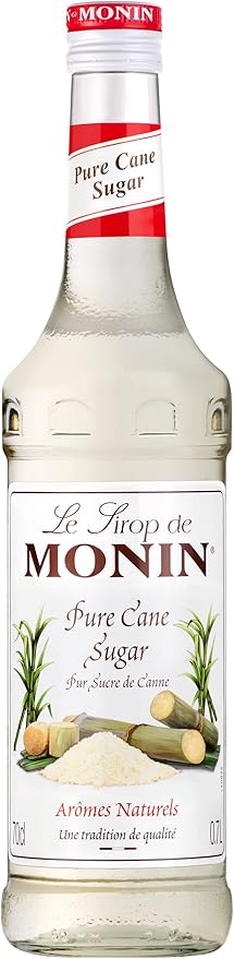 700 ml bottle of Monin Premium Pure Cane Sugar Syrup with clear liquid inside, labeled vegan-friendly, allergen-free, and free from artificial flavors or colors, ideal for coffee, cocktails, and cold beverages.