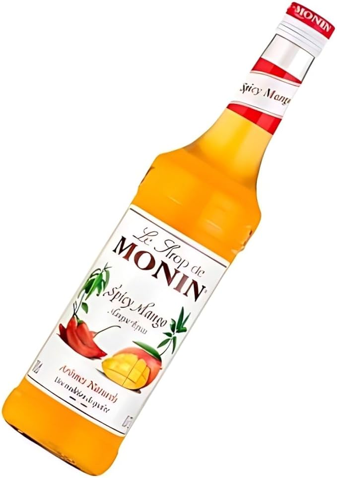 Monin Premium Mango Syrup 700ml bottle featuring sweet, tropical mango flavor. Ideal for cocktails, mocktails, iced teas, smoothies, and desserts. Vegan, allergen-free, and made with 100% natural ingredients.