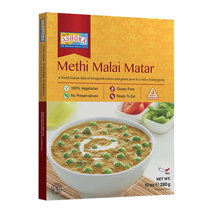 A box of Ashoka's Methi Malai Matar, a North Indian dish of fenugreek leaves and green peas in a creamy gravy. The packaging features a golden-yellow background with a red Ashoka logo, and an image of the prepared dish in a white bowl with green peas and a cream swirl.