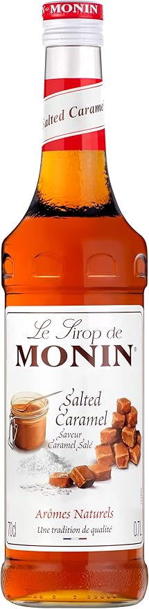 700 ml bottle of Monin Salted Caramel Syrup, rich amber liquid with buttery caramel and subtle sea salt flavor, vegan-friendly and allergen-free, ideal for coffee, cocktails, and desserts.
