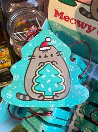 Reusable metal tin with Pusheen cat wearing a Santa hat and Christmas decorations.
