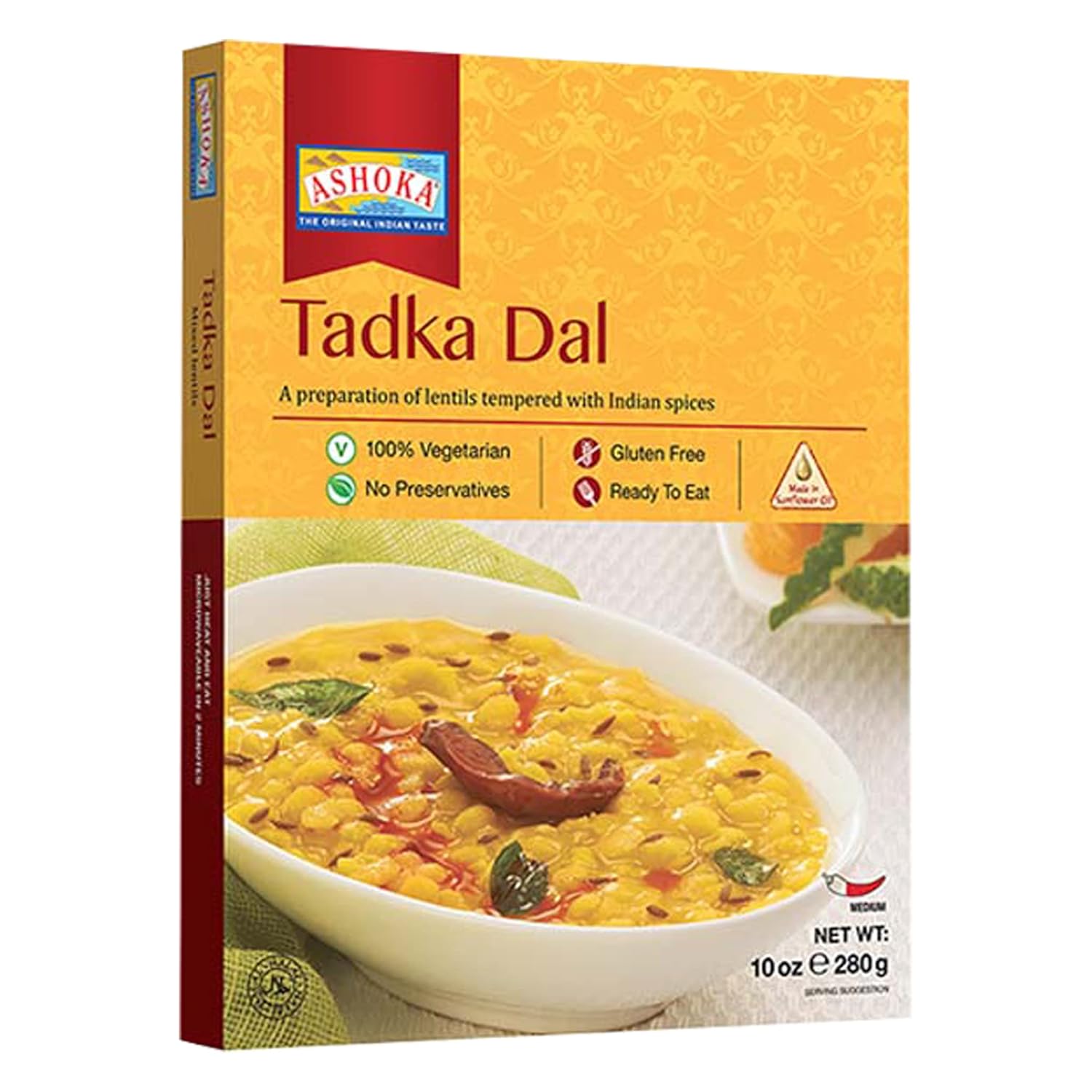 Box of Ashoka Tadka Dal with a bowl of dal on a white background