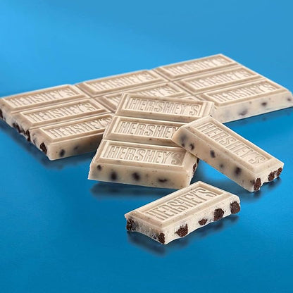 Unwrapped Hershey’s Giant Cookies ’n’ Crème Bar showing creamy white chocolate with cookie chunks.