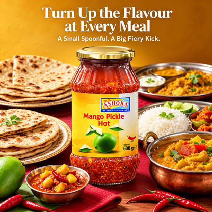 Ashoka Mango Pickle Hot 500g jar displayed with Indian naan, chapati, rice, curry, fresh mangoes and red chillies, showcasing a spicy and tangy mango achar accompaniment for everyday Indian meals.