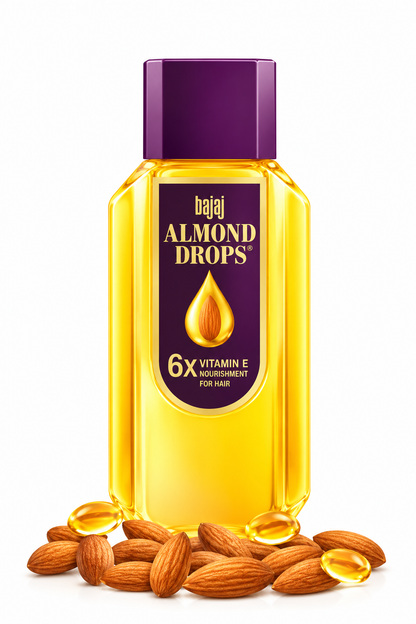 Bajaj Almond Drops Hair Oil 475ml bottle featuring golden-yellow oil, a deep purple cap and a purple and gold label with the Bajaj Almond Drops branding and almond droplet graphic, displayed with almonds and golden oil droplets against a clean white background for an online hair care product listing.