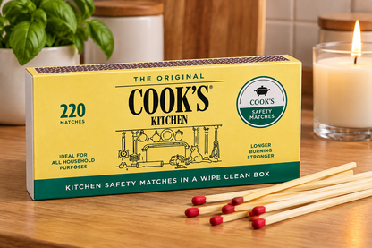 Cook’s Safety Matches box with cream and green packaging, long wooden matches and a warm kitchen countertop setting