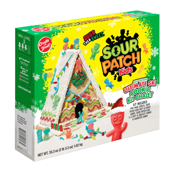 Family decorating the Sour Patch Kids Ultimate Ski Chalet Cookie Kit 35.3oz with candies and icing