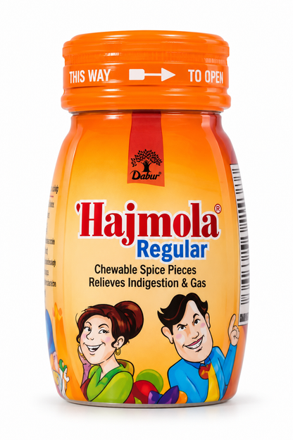 Dabur Hajmola Regular chewable spice tablets in an orange and cream jar with an orange cap, red Hajmola branding, blue Regular text, and colorful cartoon characters on the label, shown against a clean white background.