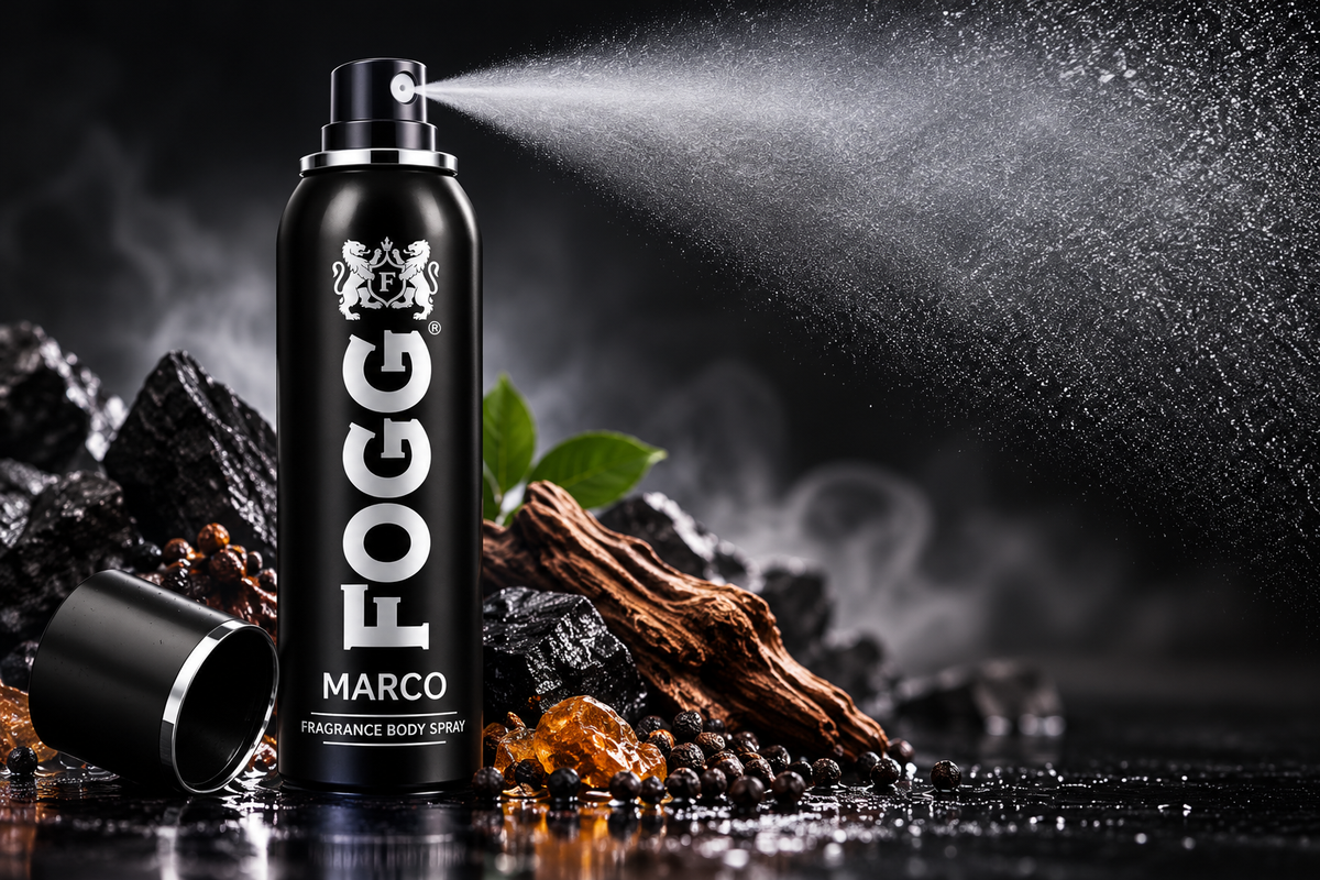 FOGG Marco 120ml black fragrance body spray can releasing a fine mist against a dramatic dark background, with smoky effects, amber accents and a reflective surface for a premium fragrance advertisement.