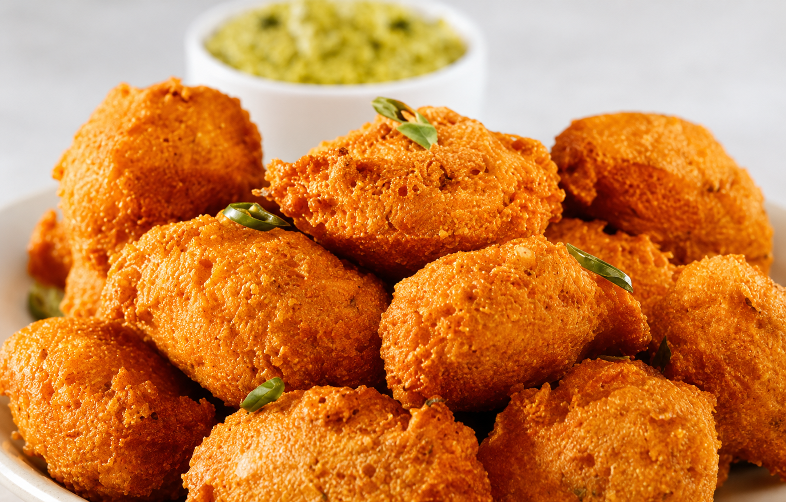 Gits Moong Dal Vada Mix prepared crispy Indian lentil fritters served on a white plate, golden and crunchy snack made from green gram lentils.