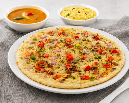 Freshly prepared Gits Uttappam topped with onions, tomatoes and green chillies, served with traditional South Indian sambar and coconut chutney.