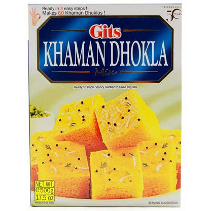 Gits Khaman Dhokla Mix 500g box packaging featuring soft yellow steamed dhokla cubes garnished with mustard seeds, ready-to-cook Indian savory mix.