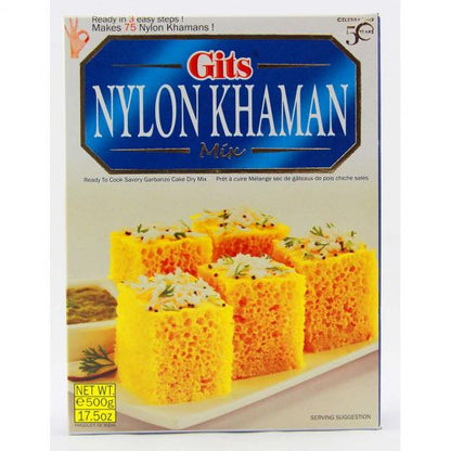 Gits Nylon Khaman Mix 500g box packaging showing soft yellow khaman dhokla cubes garnished with mustard seeds and herbs on a white plate.