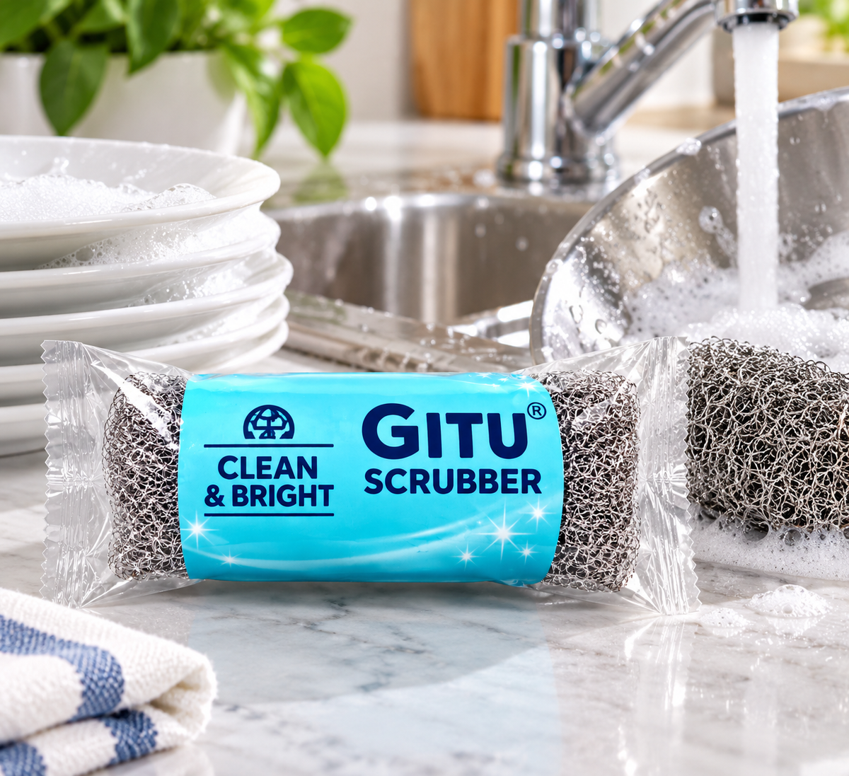 GITU Clean & Bright stainless steel scrubber for cleaning dishes and utensils in a kitchen sink.