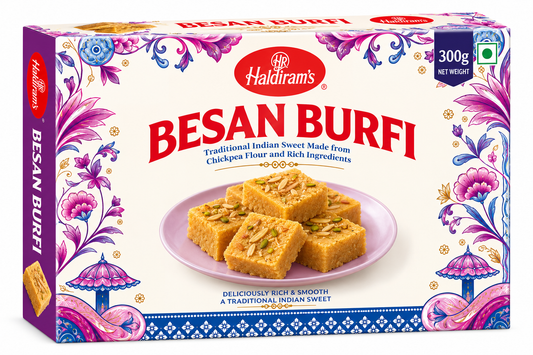 Haldiram’s Besan Burfi 300g traditional Indian chickpea flour sweets garnished with nuts in decorative cream, pink and purple packaging.
