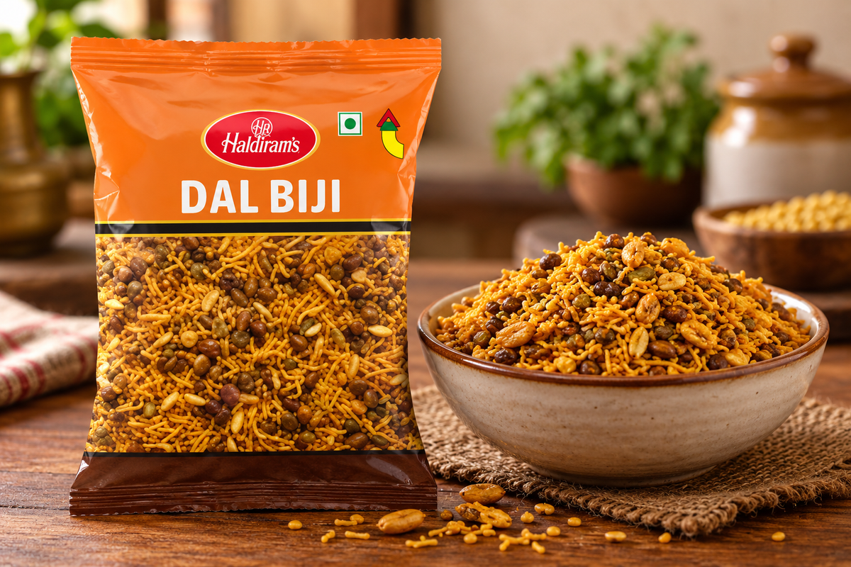 Haldiram Dal Biji 200g snack packet displayed beside a bowl of crunchy savoury dal biji mixture on a rustic wooden table.