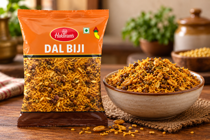 Haldiram Dal Biji 200g snack packet displayed beside a bowl of crunchy savoury dal biji mixture on a rustic wooden table.